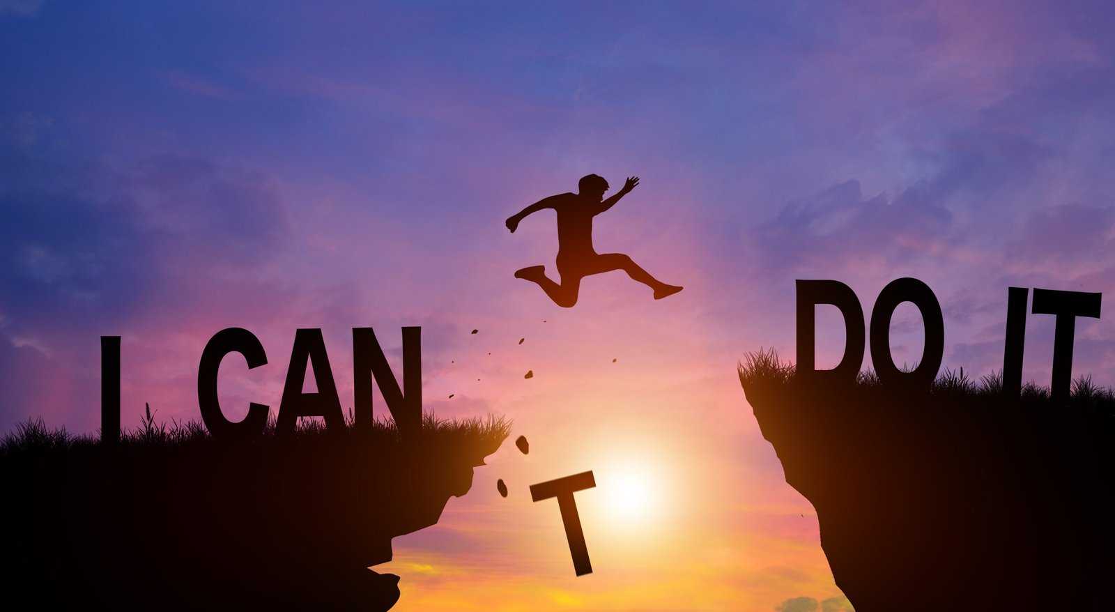 Silhouette person jumping over cliffs with I can do it word in sunlight - dreamstime_xxl_247863513